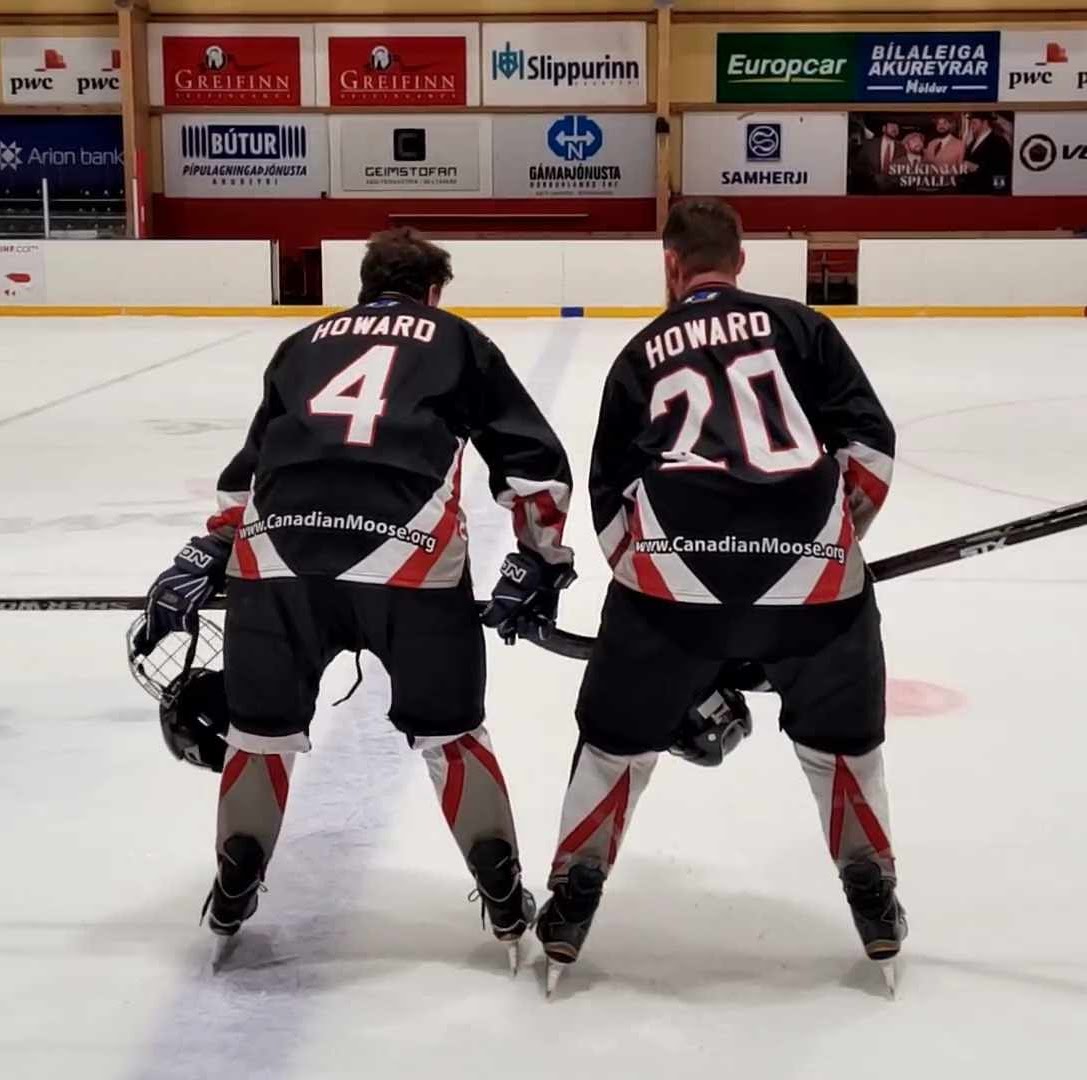 Dillon Howard and his dad on the ice after a hockey game in Akureyri, Iceland